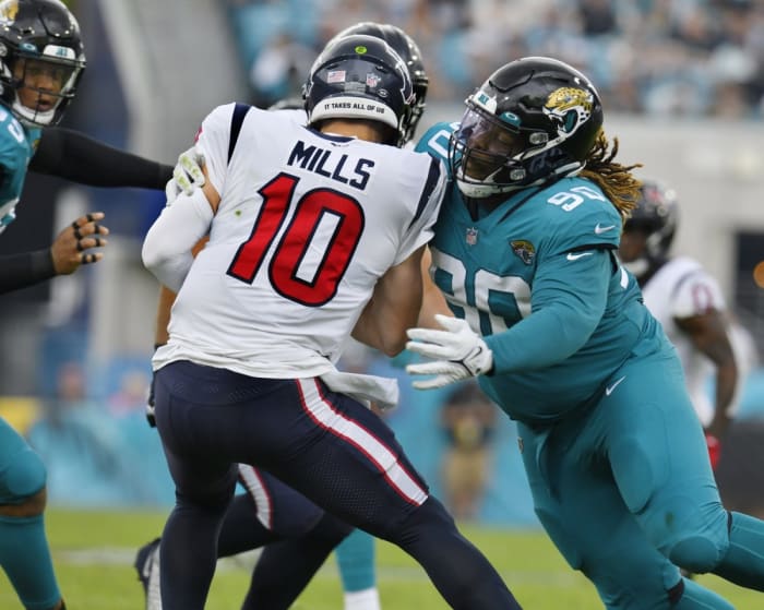 December 19, 2021; Jacksonville Jaguars defensive tackle Malcom Brown (90) sacks Houston Texans quarterback Davis Mills (10). Bob Self/Florida Times-Union / USA TODAY NETWORK